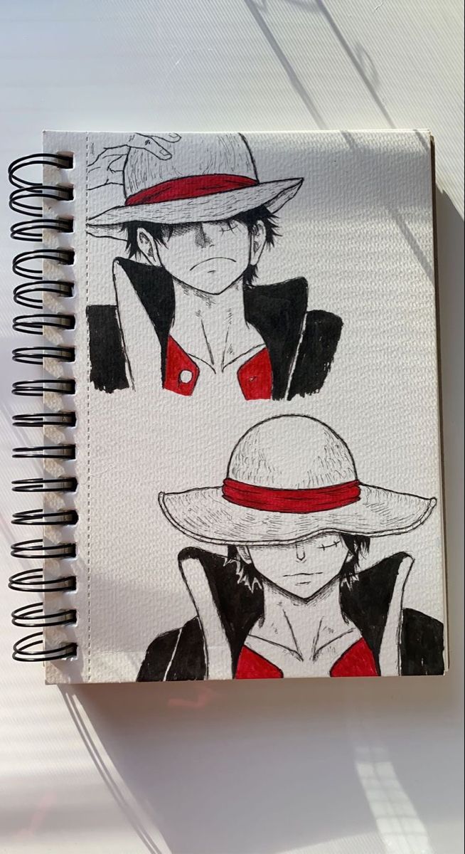 an open notebook with drawings of two people wearing hats