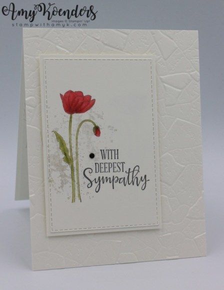 a white card with a red flower on the front and bottom, saying sympathy written in black ink