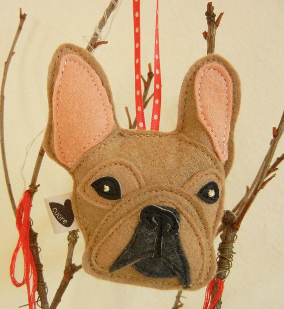 a brown dog head hanging from a tree branch