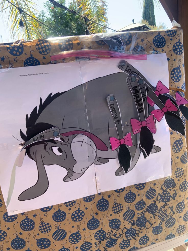 an image of a cartoon character with pink bows on it's head hanging from a bulletin board