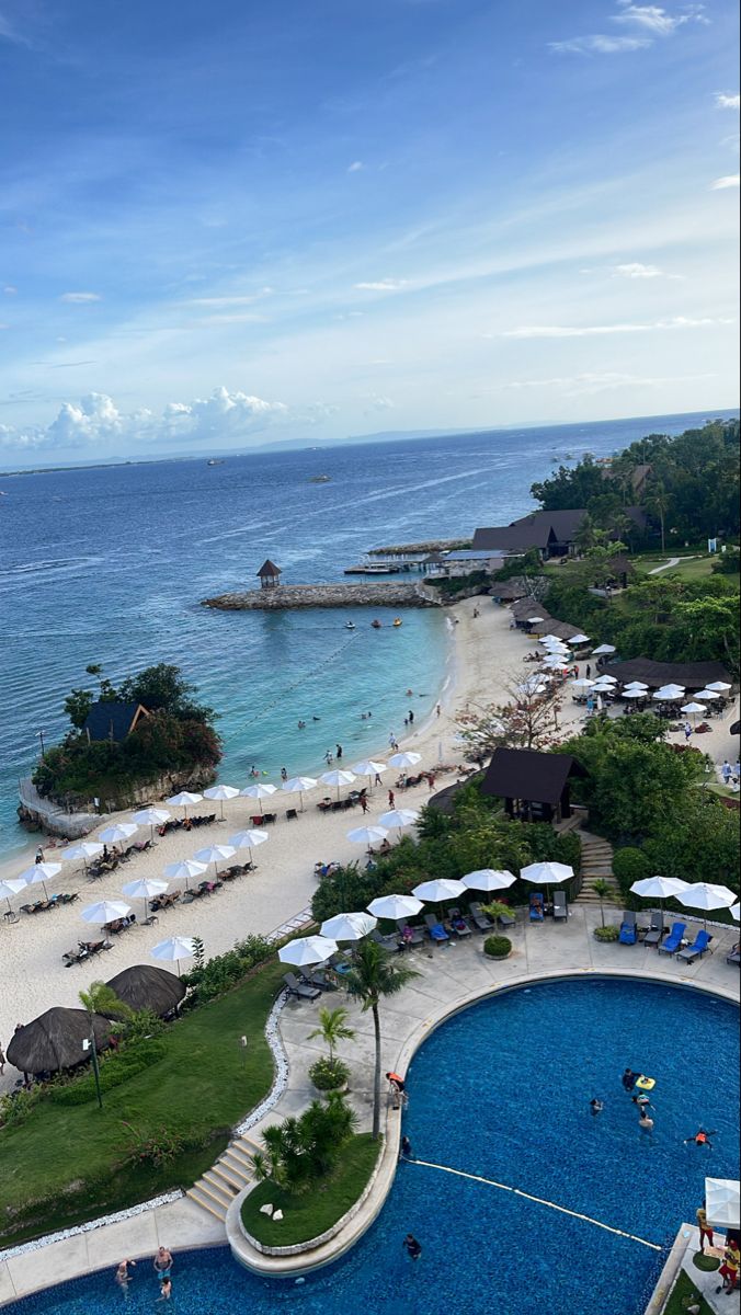 an aerial view of the beach and pool area