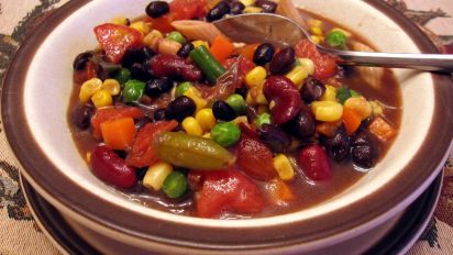 a white bowl filled with beans and corn