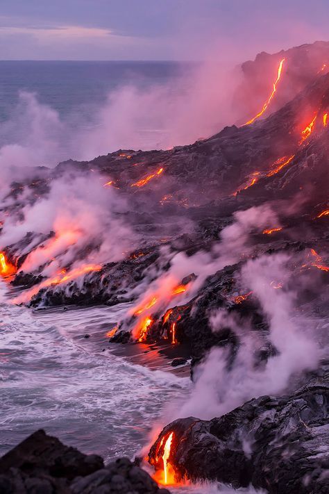 lava flowing into the ocean at night with bright orange lights on it's sides