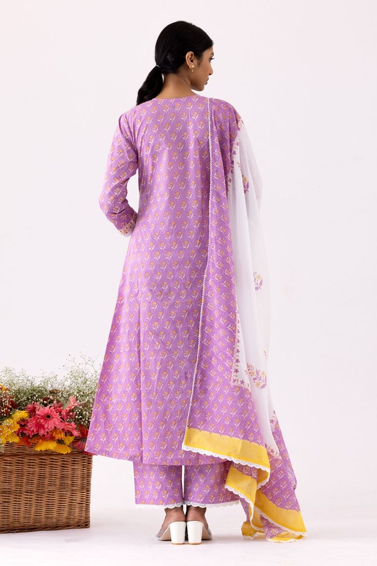 Lilac anarkali with all over floral block print, contrast floral scalloped print front panel and crochet lace work details. Paired with pant with floral print and mulmul dupatta with crochet lace border.
Components: 3
Pattern: Printed and Embellished
Type Of Work: Floral, Scalloped Block Print and Crochet Lace Work
Neckline: V Neck
Sleeve Type: Three Quarter Sleeves
Fabric: Cotton Cambric, Dupatta: Mulmul
Color: Purple
Other Details: 
Cut work hem
Panelled anarkali
Front pintuck details
Printed Lilac Anarkali, Crochet Lace Border, Lace Border, Cut Work, Set For Women, Three Quarter Sleeves, Anarkali, Aza Fashion, Crochet Lace