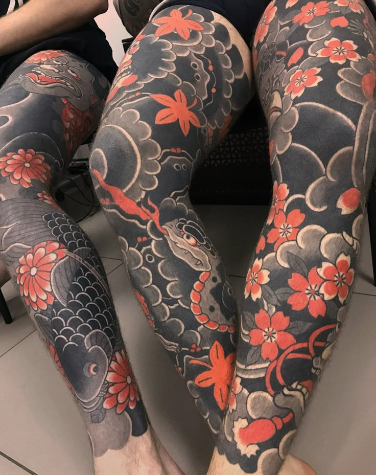 a woman with tattoos on her legs and leggings