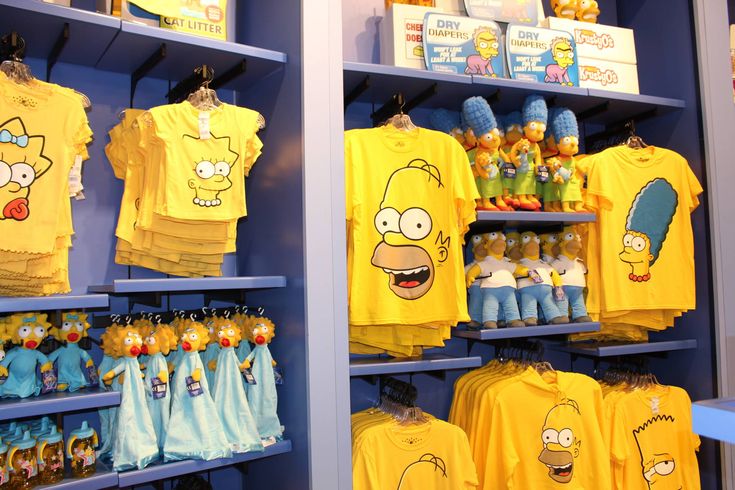 the simpsons shirts are on display in the store for children's wear and merchandise