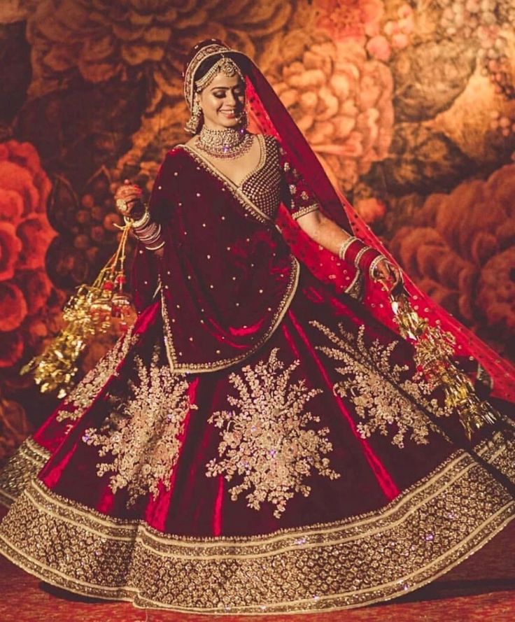 a woman in a red and gold bridal gown