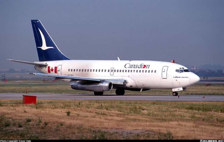 a canadian airplane is on the runway at an airport