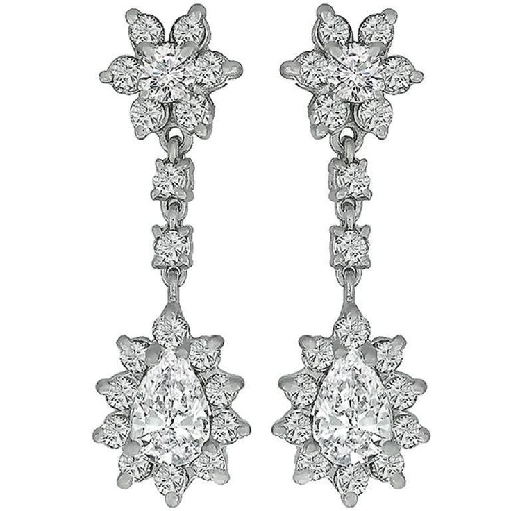 This beautiful pair of 14k white gold diamond earrings, center two stunning pear shape diamonds that weigh approximately 1.25ct. Accentuating these diamonds are high quality round cut diamonds weighing approximately 2.50ct. The diamonds are graded as G color with VS clarity. Inventory #72901PEBS Luxury Hallmarked Exquisite Diamond Earrings, Luxury Statement Diamond Earrings For Gift, Luxury Festive Earrings With Diamond Accents, Luxury Diamond Danglers For Gift, Luxury Drop Danglers With Intricate Design, Luxury Costume Jewelry With Matching Earrings, Luxury Diamond Earrings With Intricate Design, Luxury Hand Set Exquisite Diamond Earrings, Luxury Ornate Earrings With Diamond Accents