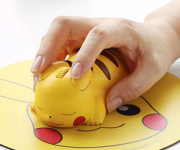 a child's hand is playing with a yellow toy elephant on top of a table