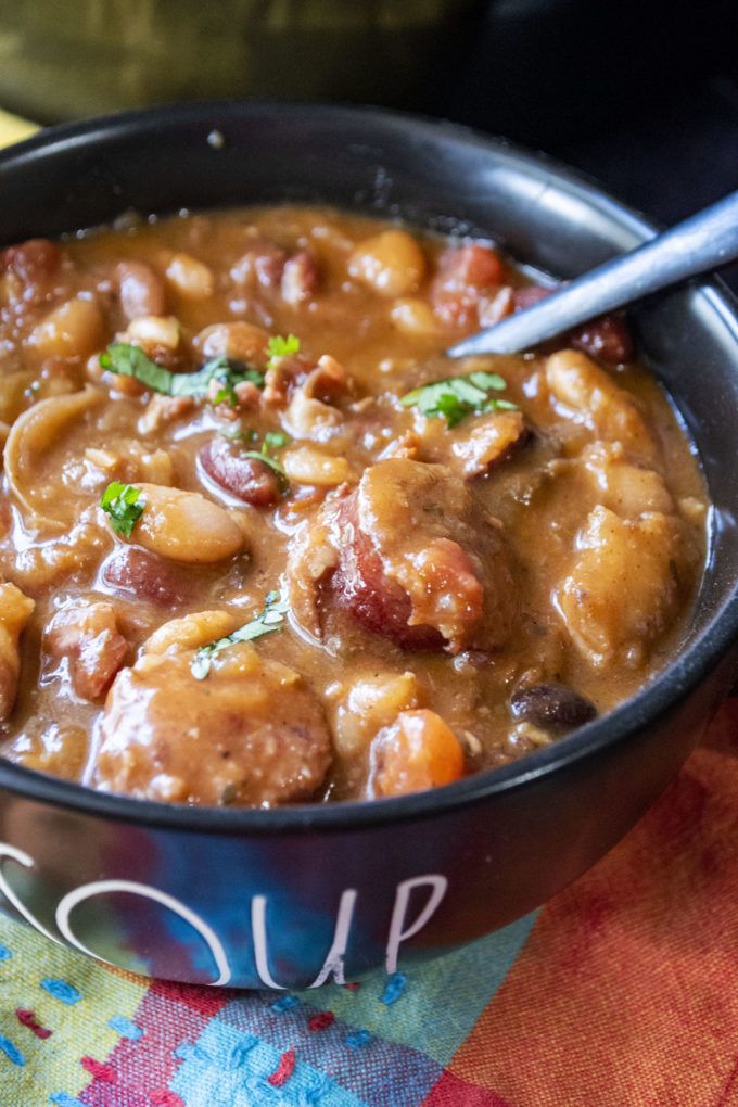 a close up of a bowl of food on a cloth with a spoon in it