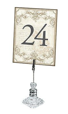 the number twenty four is hanging from a glass holder with a rope attached to it