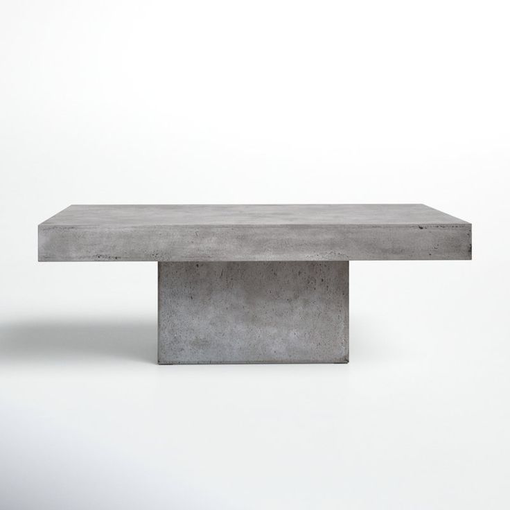 a concrete table sitting on top of a white floor