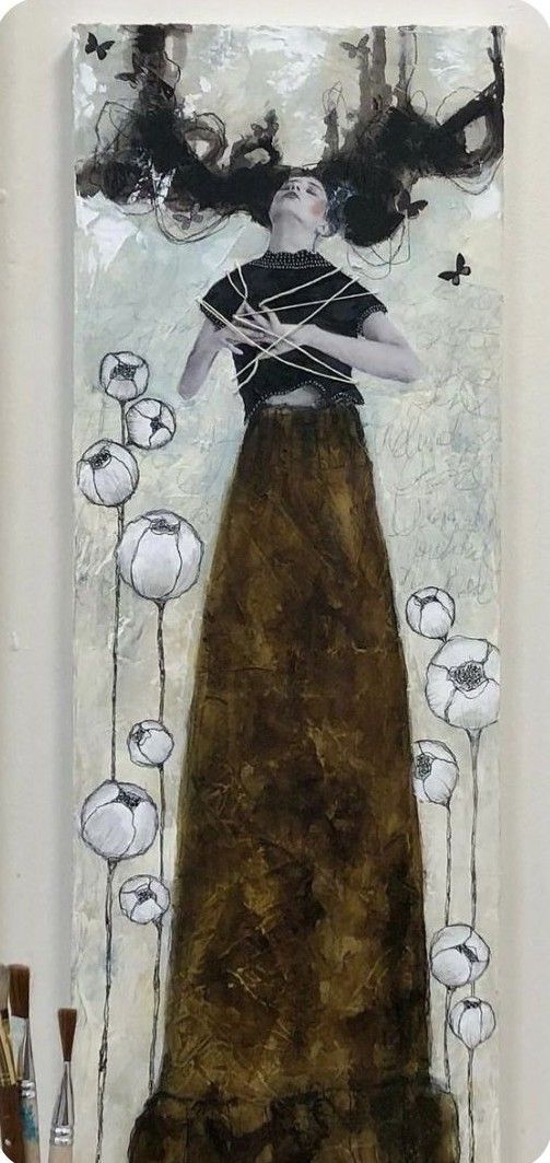 a painting on a wall with flowers and a woman's face in the center