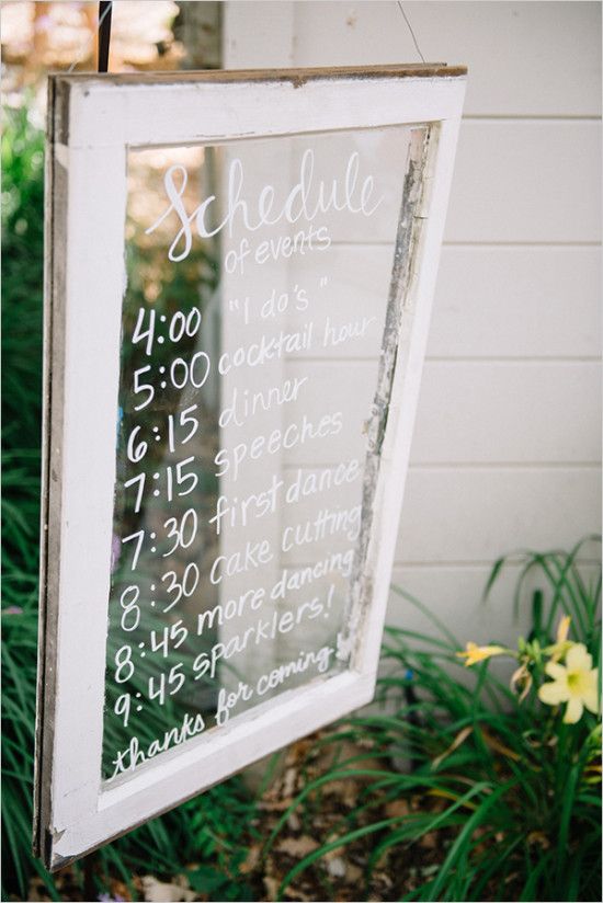 a sign hanging from the side of a building with writing on it that says schedule