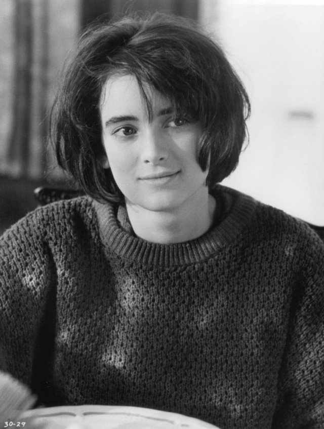 a black and white photo of a woman wearing a sweater