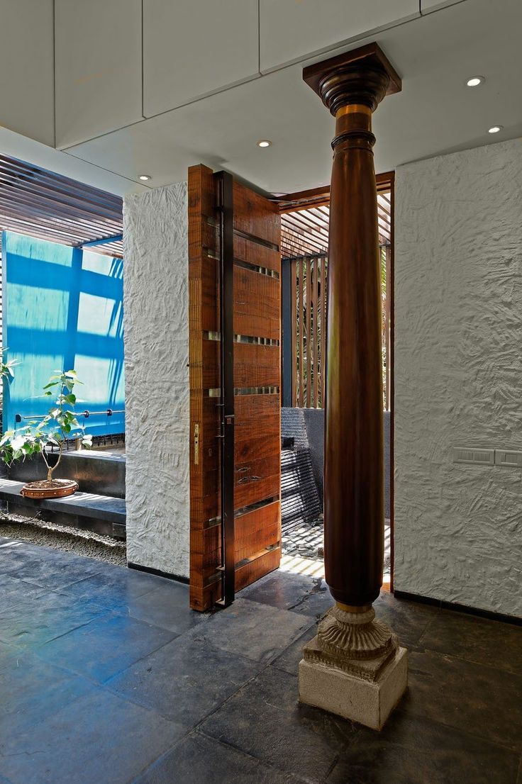 an entrance way to a modern home with large columns