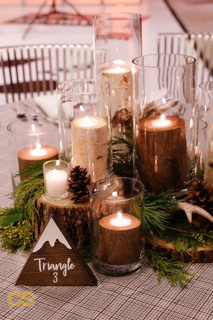 a table with candles and pine cones on it