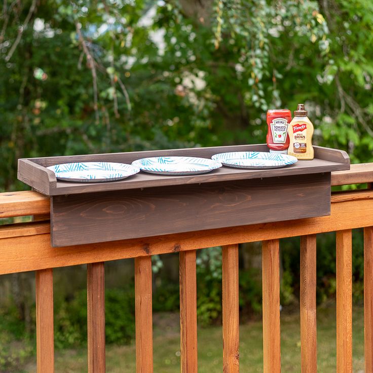 three plates are sitting on top of a wooden tray that is holding ketchup and mustard