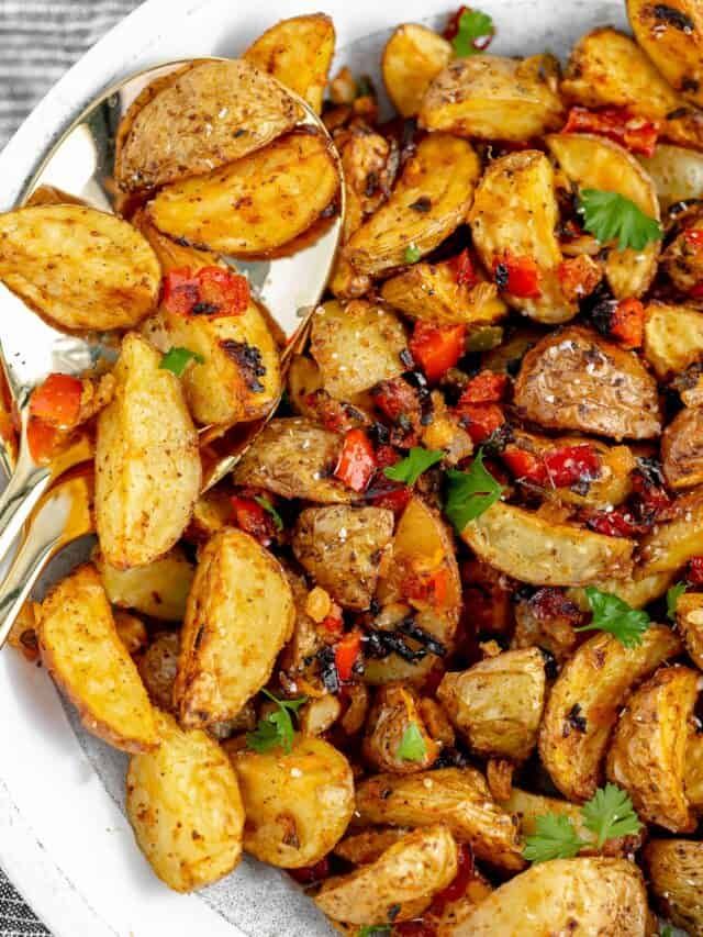 a white bowl filled with cooked potatoes on top of a table