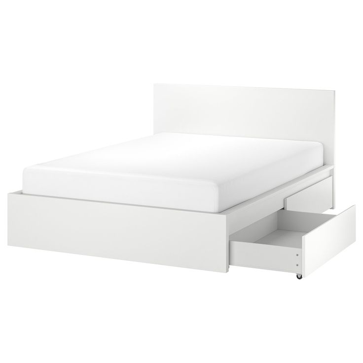 a white bed with two drawers underneath it