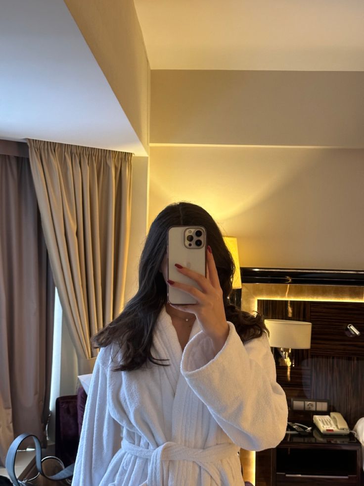 a woman taking a selfie in a hotel room