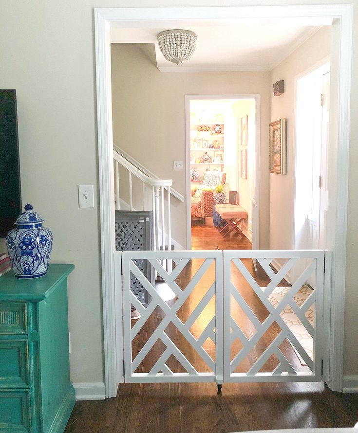 an open door leading to a living room with a tv on top of a dresser