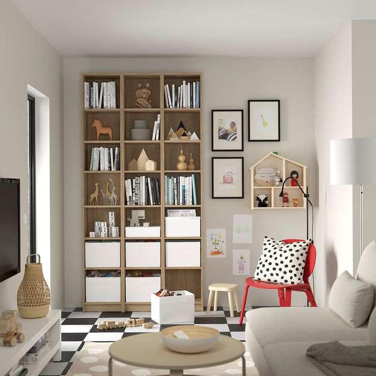 a living room filled with furniture and a flat screen tv sitting on top of a wooden shelf