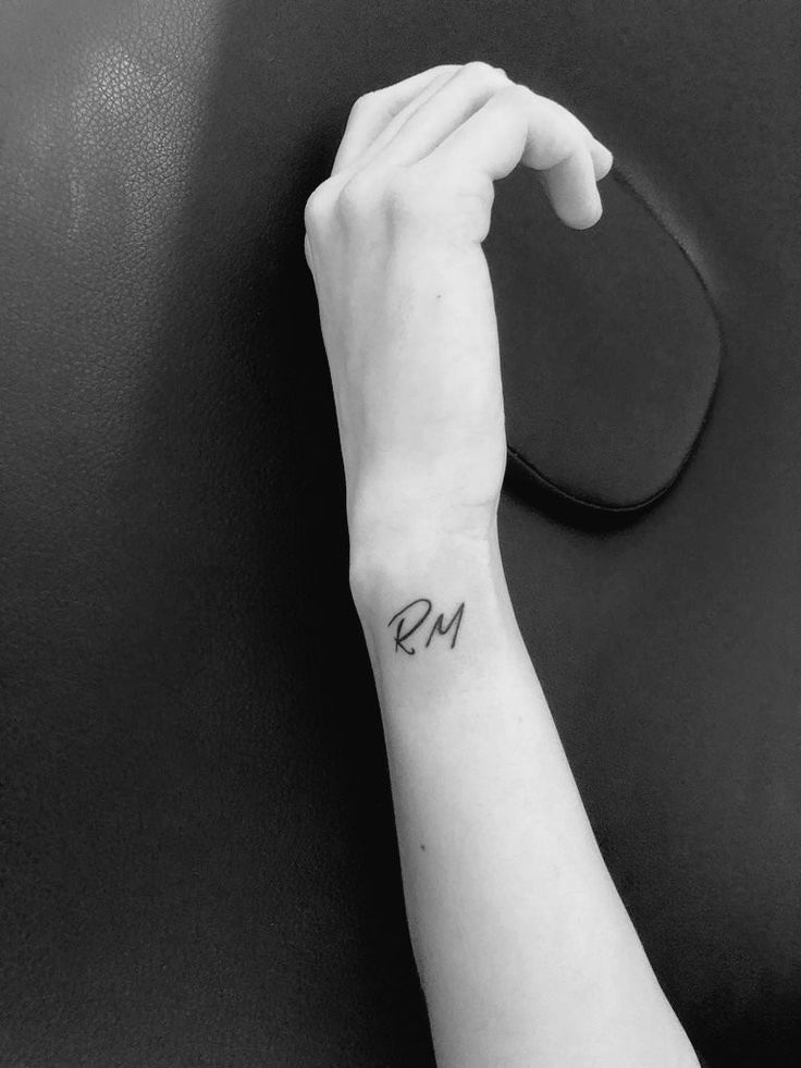 a woman's arm with a small wrist tattoo on the left side of her hand