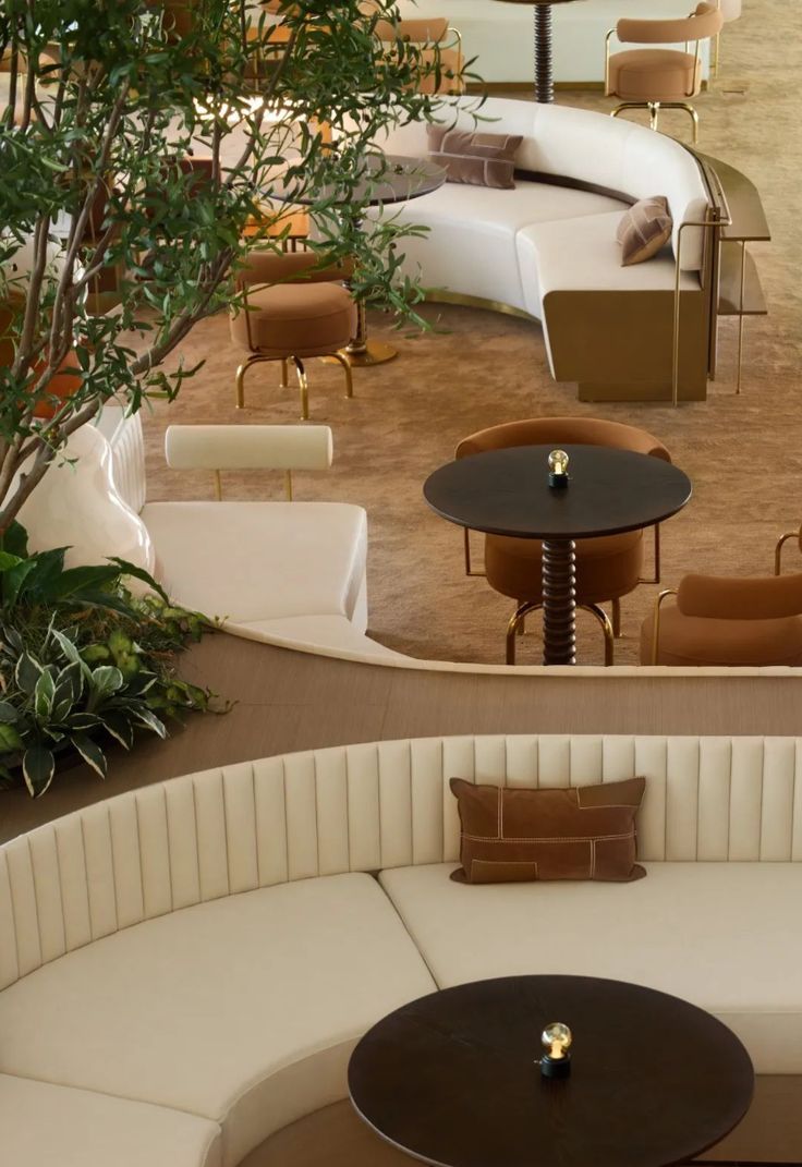 an overhead view of a seating area with round tables and couches in the center