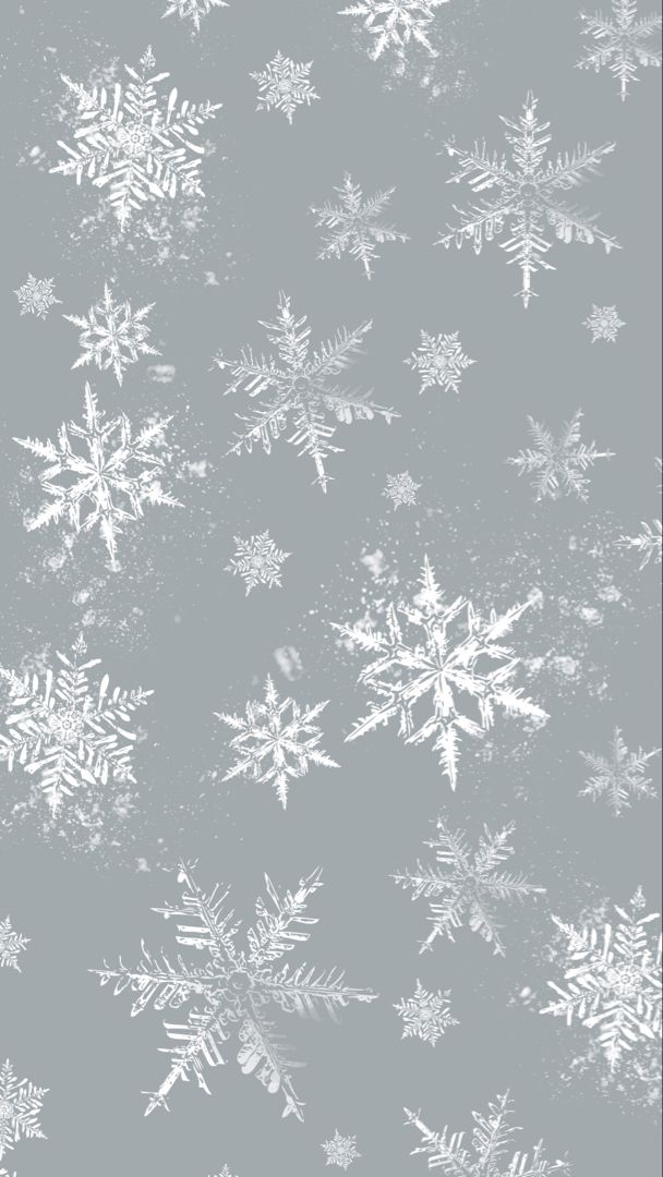 A phone wallpaper with an icy blue background with white delicate snowflakes in different sizes around the screen. White Snowflake Aesthetic, Winter Wallpaper Ipad Backgrounds, Winter Theme Wallpaper Aesthetic, Winter Aesthetic Background Iphone, Snowflake Pattern Wallpaper, Christmas Wallpaper Aesthetic Blue, Winter Themed Wallpaper, Christmas Asthetics Wallpaper Iphone, Snowy Background Aesthetic