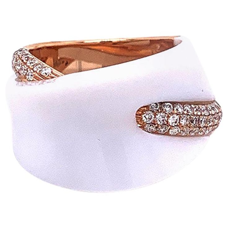 A smooth piece of white onyx sparkles on top of this modern styled ring. It is accented with 0.57 carats of round brilliant cut diamonds set in 18k rose gold. A fashionable piece that can compliment any outfit, day or night. Ring Size 5.75 Luxury White Diamond Ring With Single Cut Diamonds, Luxury White Single Cut Diamond Ring, Luxury White Rings With Diamond Accents, Modern White Diamond Ring With Accents, Luxury White Rings With Vvs Clarity, Luxury White Diamond Ring With Pave Setting, Modern White Diamond Ring With Single Cut Diamonds, Modern White Diamond Ring With Polished Finish, Modern White Diamond Ring With Vvs Clarity