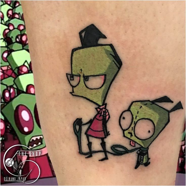 cartoon tattoos on the leg of a person with an evil looking face and green hair