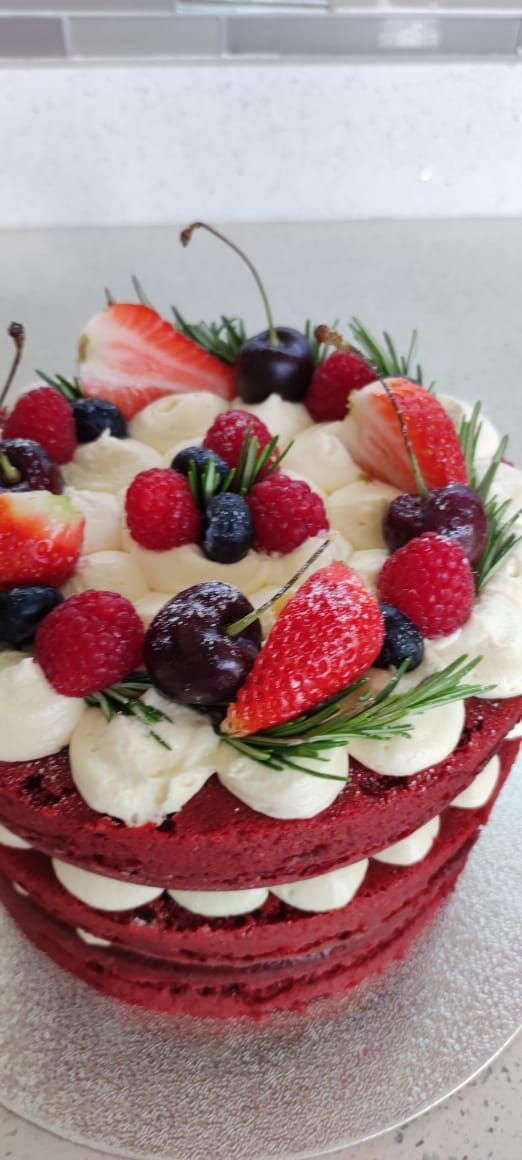 a cake with fruit and cream frosting on top