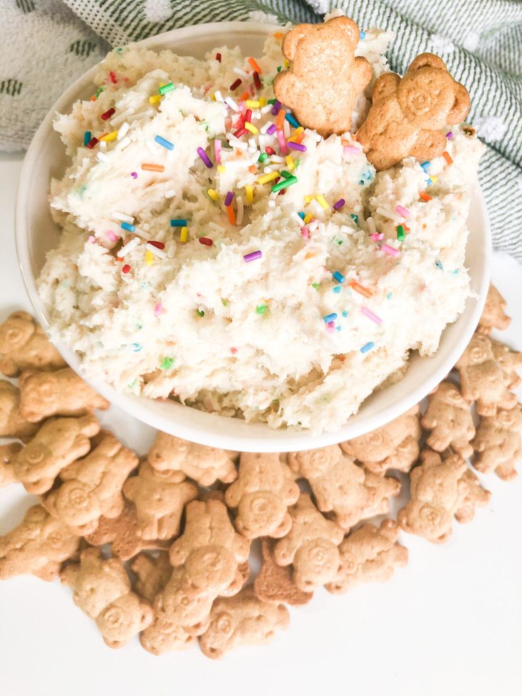 a bowl filled with rice and sprinkles next to crackers on a table