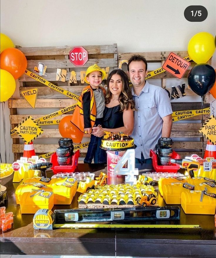 a man and two women standing in front of a table full of desserts at a construction themed birthday party