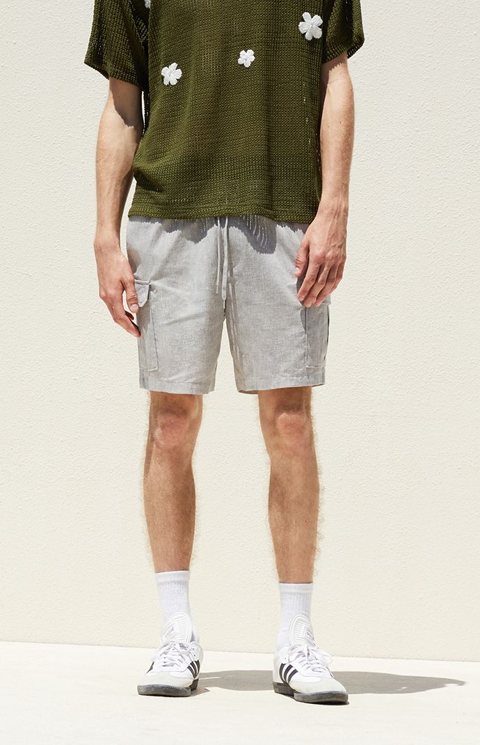 Elevate your summer style with PacSun's Linen Cargo Shorts, designed for both comfort and functionality. Crafted from a lightweight linen blend fabrication, these shorts feature a drawstring waistline and side pockets for convenience. With cargo pockets adding a touch of utility, and a standard fit ensuring a comfortable wear, they're the perfect choice for all your warm-weather adventures.


	 Elastic stretch waistline
	Side pockets
	Cargo pockets
	Standard fit
	6.5/8" Inseam
	17" Outseam
	11.5" Front rise
	73% Cotton, 25% linen, 2% spandex
	Machine washable
	Model is wearing size medium
	Model Measurements: 6'1.5” Height, 28” Waist, 32” Inseam Cargo Shorts Men, Exclusive Collection, Tee Shop, Model Measurements, Pacsun, Summer Style, Cargo Shorts, Warm Weather, Linen Blend