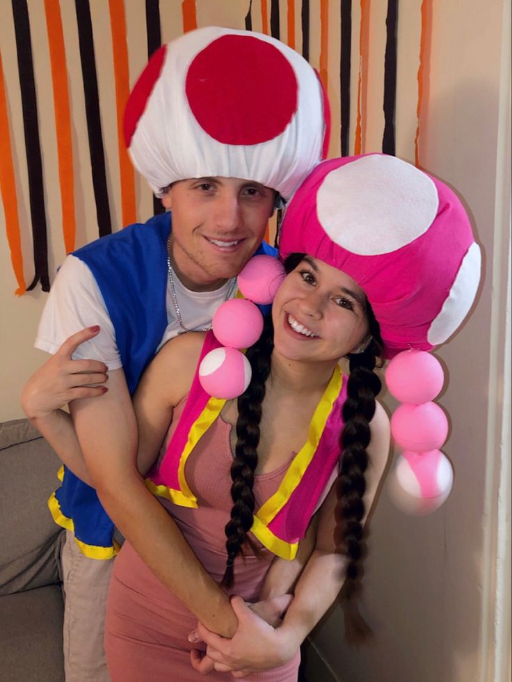 a man and woman are dressed up as mario and mushroom characters for halloween party decorations