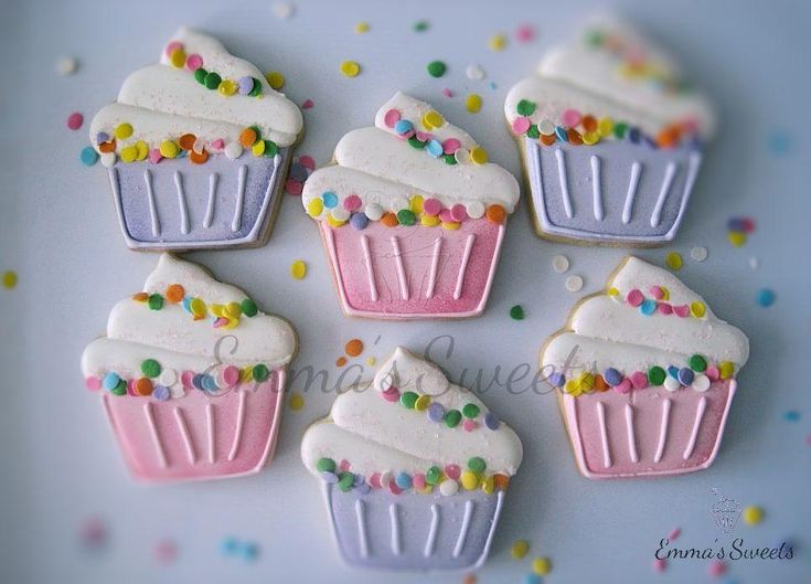 six decorated cupcakes with sprinkles on them