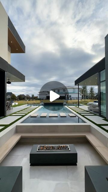 an outdoor living area with fire pit and seating