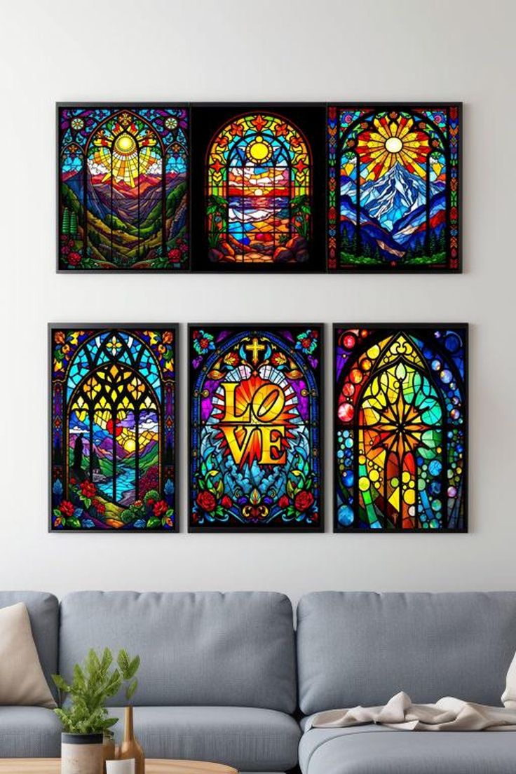 three colorful stained glass windows hanging on the wall above a gray couch in a living room