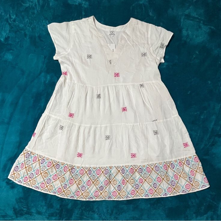 New With Tags, This Cute Dress Is Light And Flowy With Embroidered Details. Casual Multicolor Embroidered V-neck Dress, White V-neck Dress With Geometric Embroidery, Short Sleeve Cotton Dress With Geometric Embroidery, Casual V-neck Dress With Embroidered Hem, Cotton Dresses With Geometric Embroidery And Short Sleeves, White Short Sleeve Embroidered Dress With Geometric Pattern, Casual Cotton Dresses With Geometric Embroidery, White Geometric Embroidered Short Sleeve Dress, Casual V-neck Dress With Multicolor Embroidery