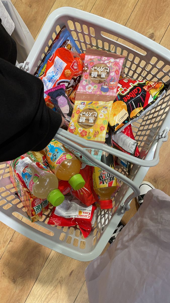 a shopping basket filled with candy and snacks