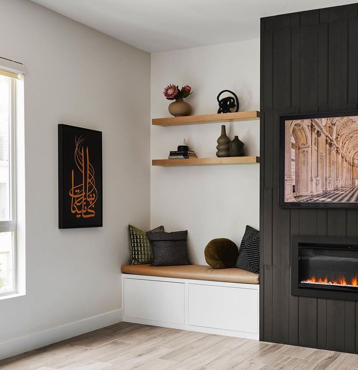 a living room filled with furniture and a fire place next to a wall mounted tv