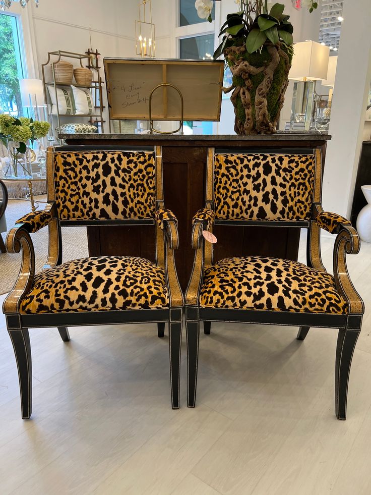 two leopard print chairs sitting next to each other