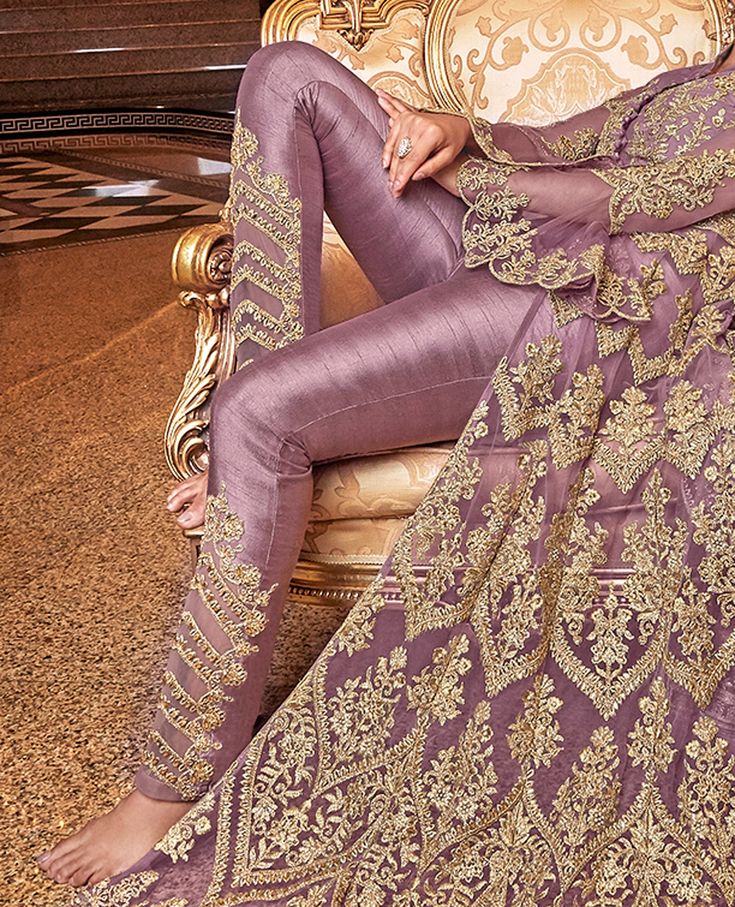 COLOR : Lavender FABRIC : Top - Premium Butterfly Net, Inner (Blouse & Lehenga) - Muslin, Bottom - Butterfly Net Lehenga & Silk Pants, Dupatta - Premium Butterfly Net WORK : Heavy Zari Work, Hand Work, Motifs, Stones, Swarvoski, Sequins, Lace Border OCCASION : Wedding, Reception, Engagement, Party Wear, Bridal WearADDITIONAL INFO : The outfit comes with complimentary embroidered silk pants besides the lehenga READY-TO-WEAR : NoSTITCHING : Available as semi-stitched fabric, can be stitched using Lehenga Silk, Bridal Anarkali Suits, Bridal Anarkali, Blouse Lehenga, Lavender Fabric, Butterfly Net, Abaya Style, Lehenga Style, Net Lehenga