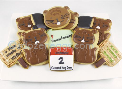 there are many decorated cookies in the shape of animals on a white plate with a price tag