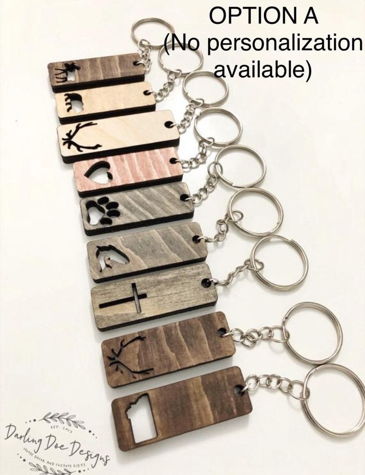 six wooden key chains with different designs on them