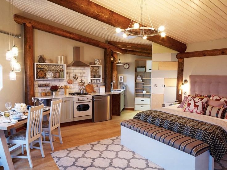 a bed sitting in a bedroom next to a kitchen