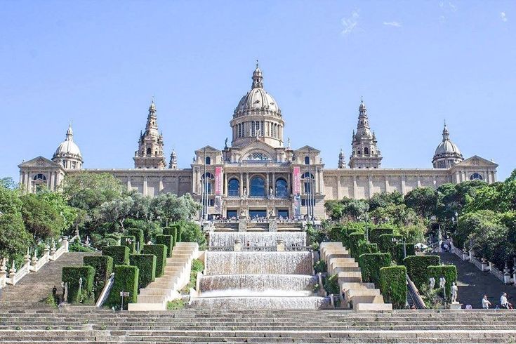 a large building with many steps leading up to it and a fountain in the middle